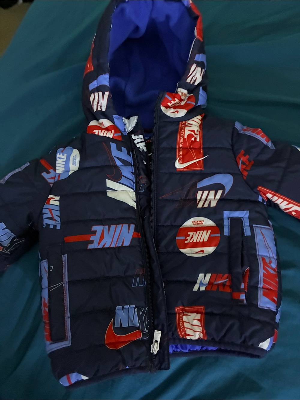 Nike Kids Navy Puffer Jacket with Red & Light Blue Graphics
